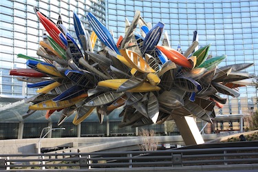 Large sculpture with canoes and other boats